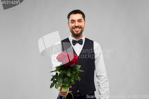 Image of happy man with bunch of red roses