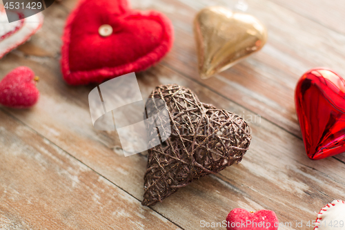 Image of heart shaped decorations on wooden background