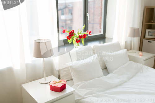 Image of gift in shape of heart on bedside table in bedroom