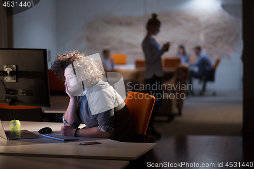 Image of man working on computer in dark office