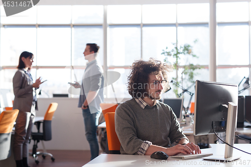 Image of businessman working using a computer in startup office