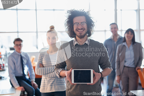 Image of Portrait of a young businessman holding tablet