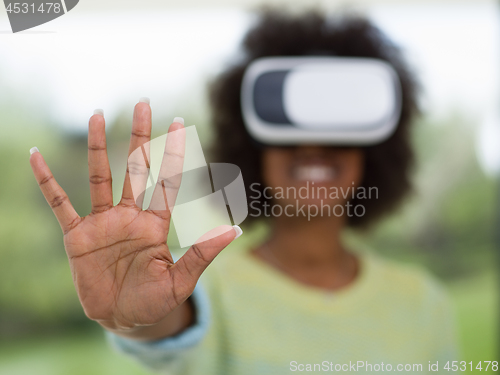 Image of black woman using VR headset glasses of virtual reality