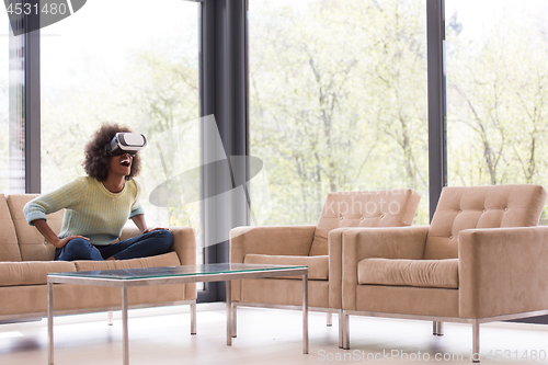 Image of black woman using VR headset glasses of virtual reality