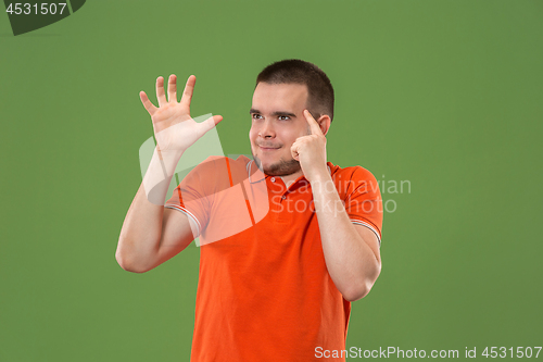 Image of Young serious thoughtful businessman. Doubt concept.