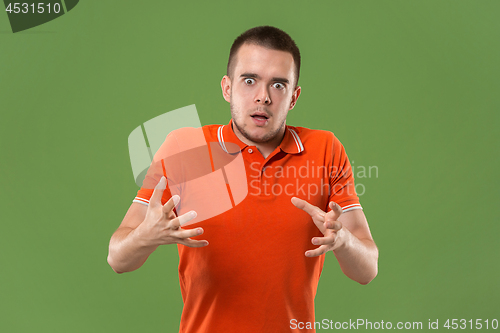 Image of The young emotional angry and scared man standing and looking at camera