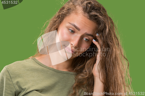 Image of Young serious thoughtful woman. Doubt concept.