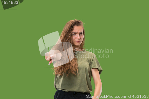 Image of The overbearing business woman point you and want you, half length closeup portrait on green background.