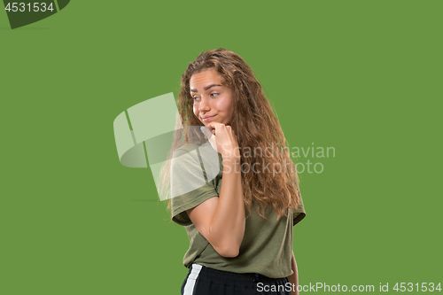 Image of Young serious thoughtful woman. Doubt concept.