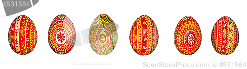 Image of Wooden Easter eggs, painted in patterns by hand with acrylic paints, isolated on a white background.