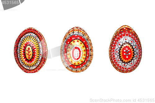 Image of Wooden Easter eggs, painted in patterns by hand with acrylic paints, isolated on a white background.