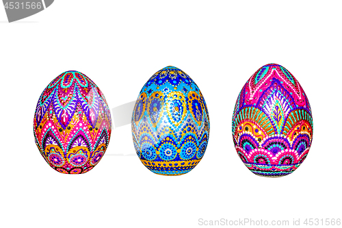 Image of Wooden Easter eggs, painted in patterns by hand with acrylic paints, isolated on a white background.