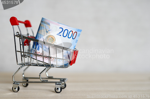 Image of Russian money banknotes in a shopping trolley, online shopping concept.