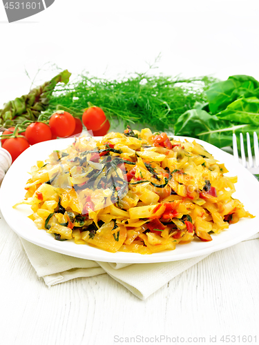 Image of Cabbage stew with chard in plate on wooden board