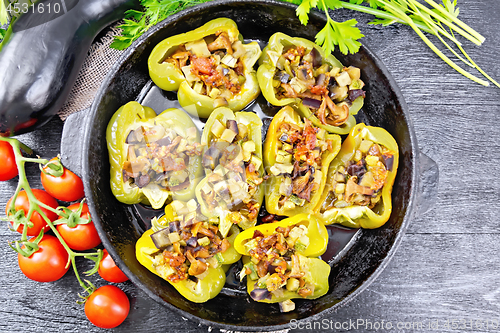 Image of Pepper stuffed with vegetables in pan on board top