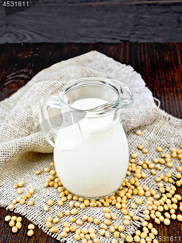 Image of Milk soy in jug with soybeans and leaf on sacking