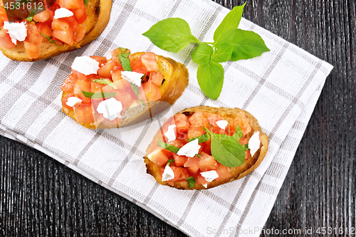 Image of Bruschetta with tomato and feta on board top