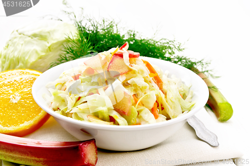 Image of Salad of cabbage and rhubarb in plate on light wooden board