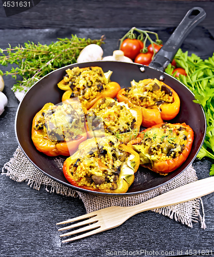 Image of Pepper stuffed with mushrooms and couscous in pan on table