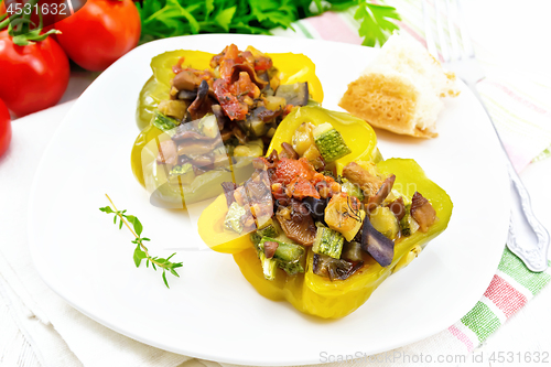 Image of Pepper stuffed with vegetables in plate on board