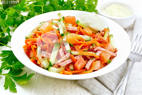 Image of Salad of sausage and spicy carrots on wooden board