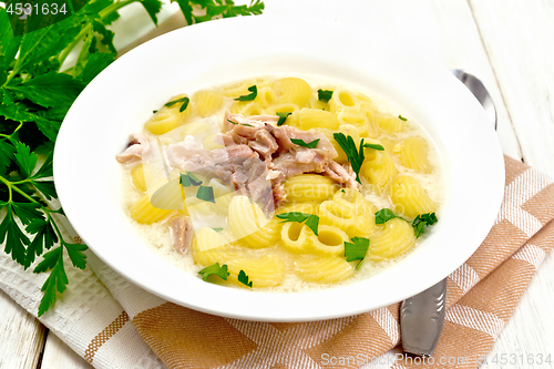 Image of Soup creamy of chicken and pasta in plate on table