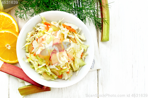 Image of Salad of cabbage and rhubarb in plate on board top