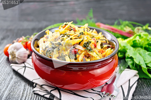 Image of Cabbage stew with chard in bowl on board