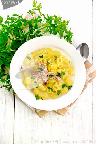 Image of Soup creamy of chicken and pasta in plate on light board top