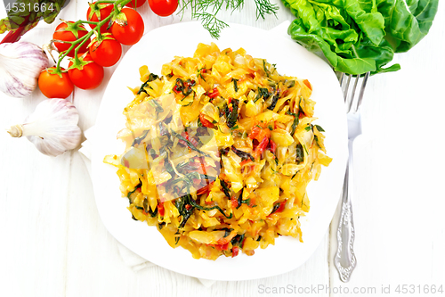 Image of Cabbage stew with chard in plate on board top