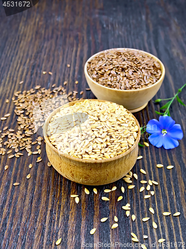 Image of Flaxen white and brown seed in bowl with flower on board