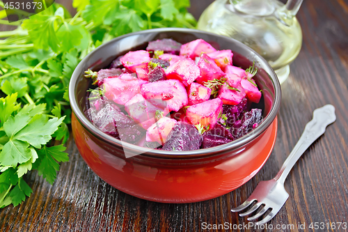 Image of Salad of beets and potatoes in bowl on dark board