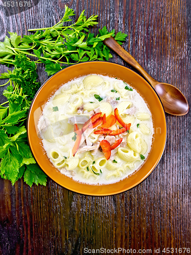 Image of Soup creamy of chicken and pasta with pepper in plate on board t