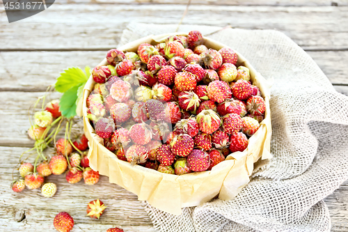 Image of Strawberries in box on old board