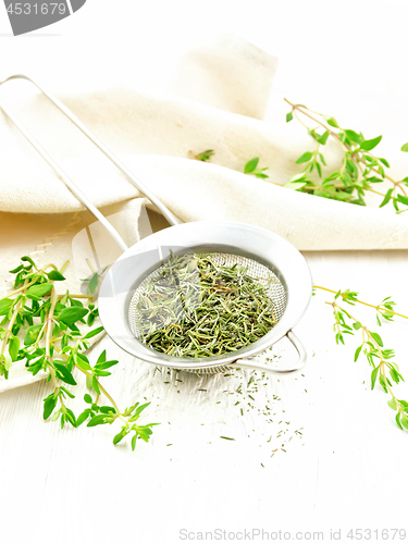 Image of Thyme dry in strainer on light board