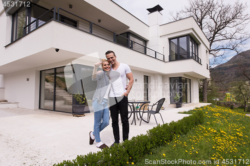 Image of couple hugging in front of  new luxury home