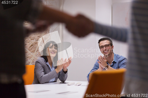 Image of cloasing the deal in modern office interior