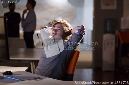 Image of businessman relaxing at the desk