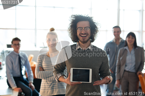 Image of Portrait of a young businessman holding tablet