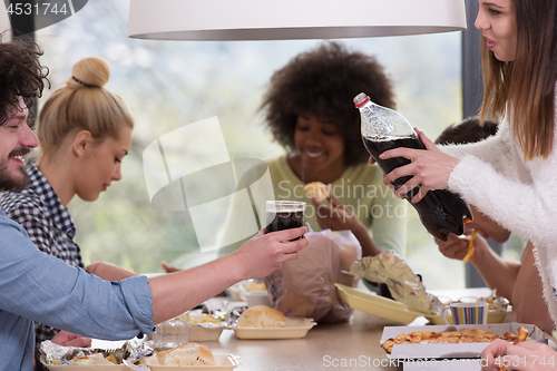 Image of multiethnic group of happy friends lunch time