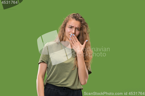 Image of Let me think. Doubtful pensive woman with thoughtful expression making choice against green background