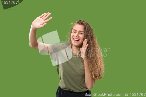 Image of Isolated on green young casual woman shouting at studio