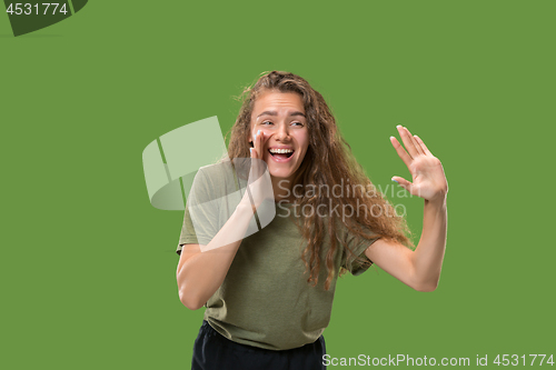 Image of Isolated on green young casual woman shouting at studio