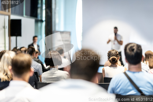 Image of Male business speaker giving a talk at business conference event.