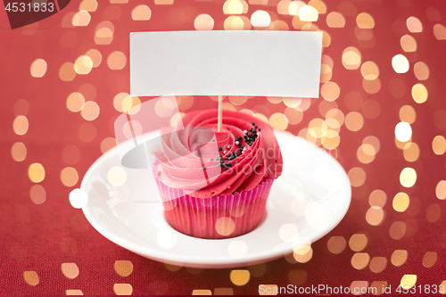 Image of close up of cupcake with red buttercream frosting