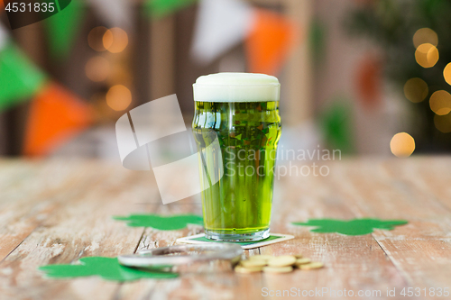 Image of glass of green beer, horseshoe and golden coins