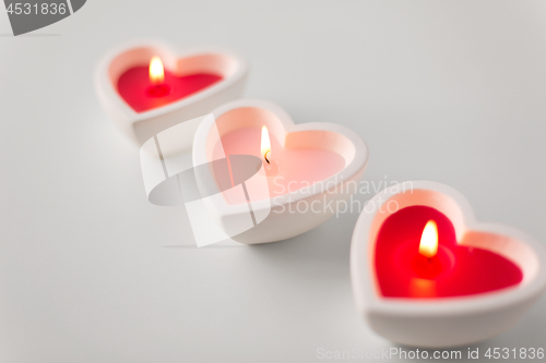 Image of heart shaped candles burning on valentines day