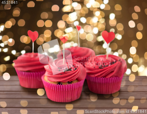 Image of close up of cupcakes with heart cocktail sticks