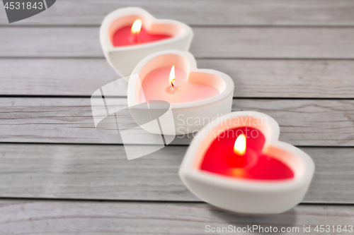 Image of heart shaped candles burning on valentines day