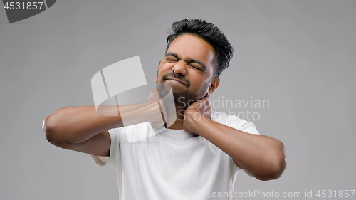 Image of tired indian man suffering from neck pain